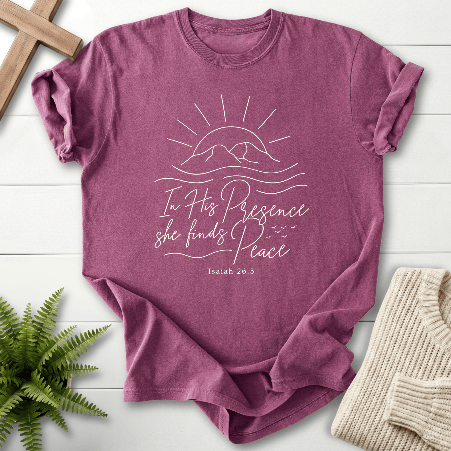 Berry women's Christian t-shirt with sunrise line art and a soft mountain glow, inspired by Isaiah 26:3.
