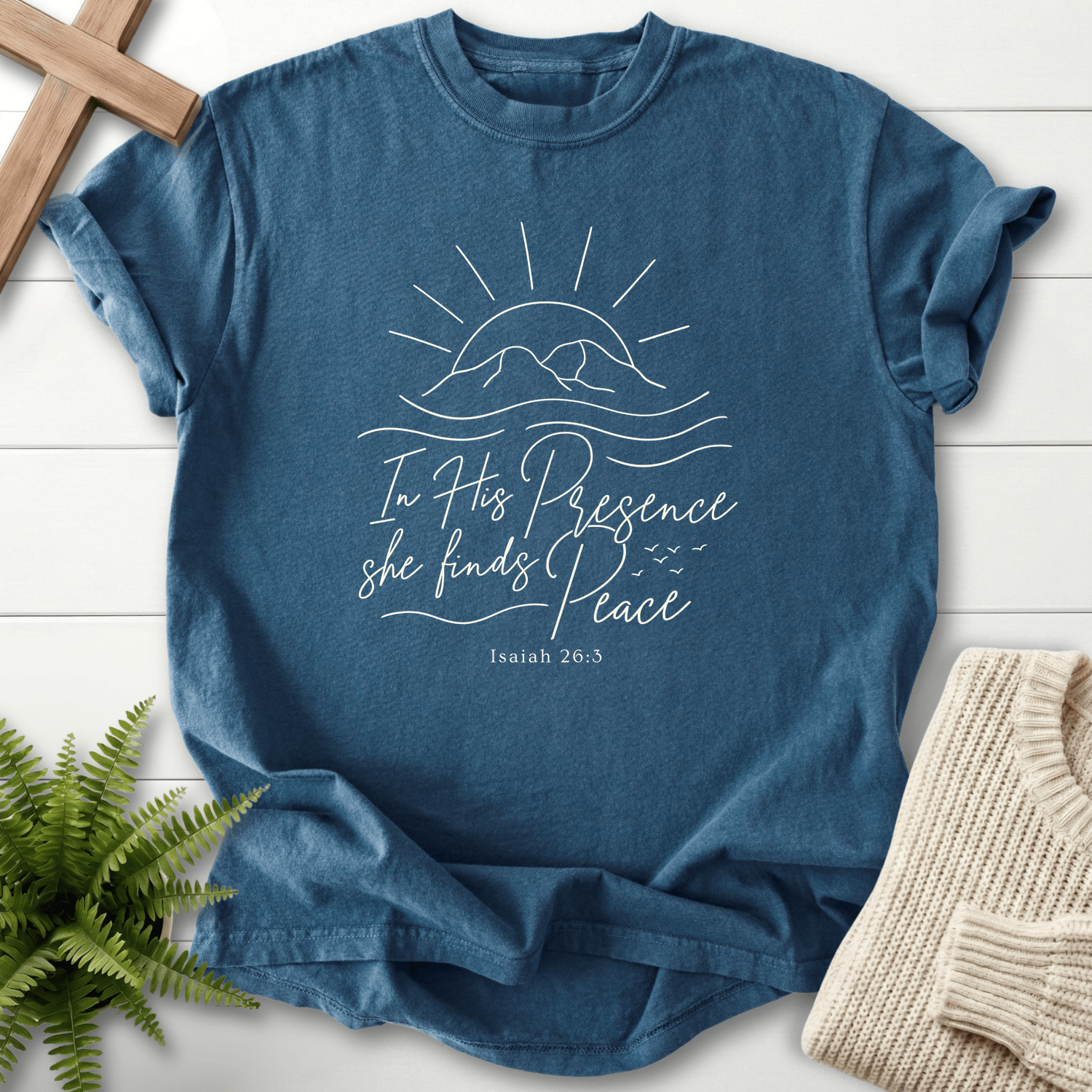 Midnight women's Christian t-shirt with a flowing mountain sunrise and cursive lettering, inspired by Isaiah 26:3.