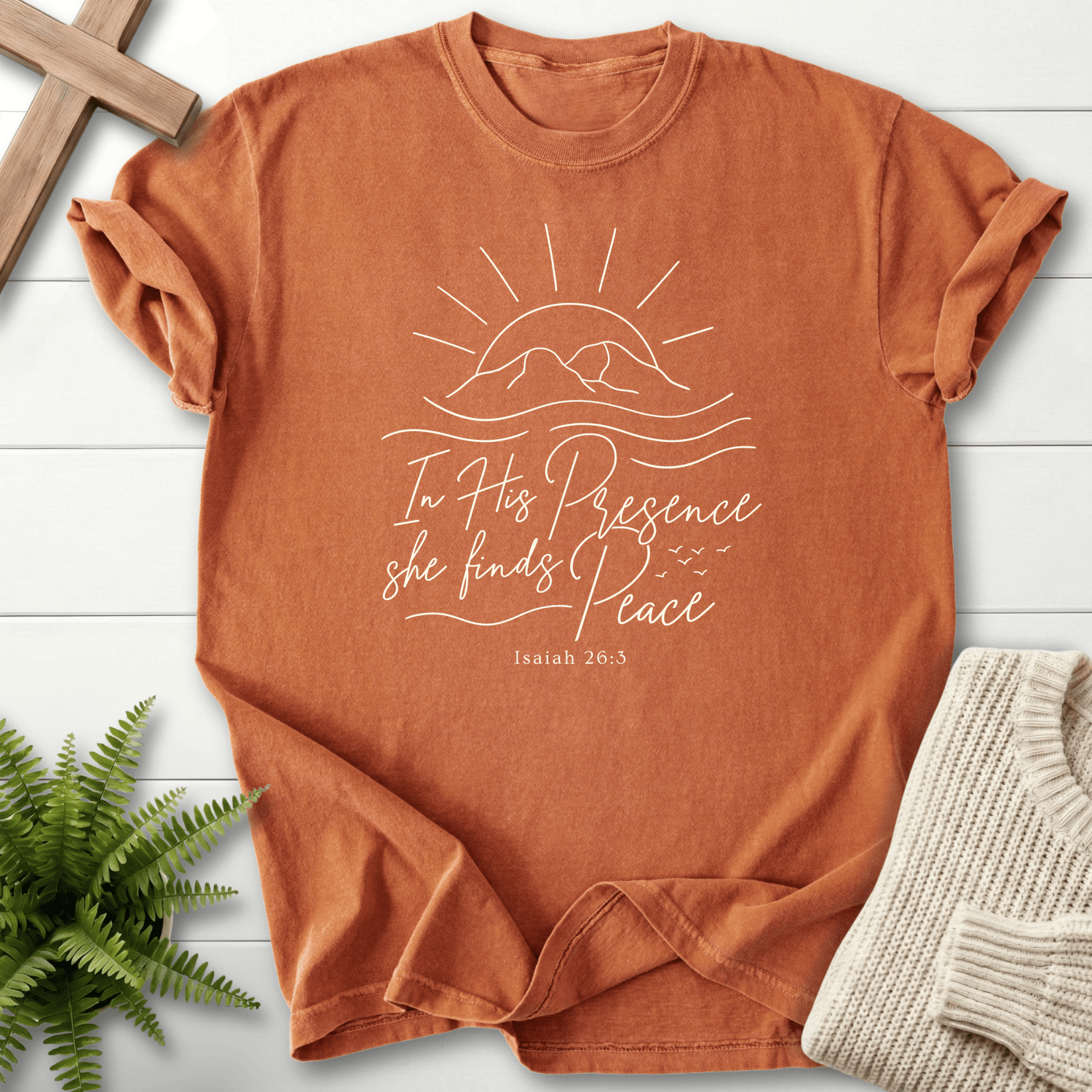 Yam women's Christian t-shirt with a minimalist sun and mountain wave design, inspired by Isaiah 26:3.