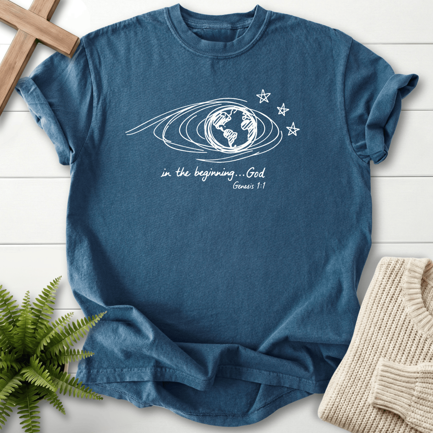 Midnight women's Christian t-shirt with a minimalist globe swirl and star art, inspired by Genesis 1:1