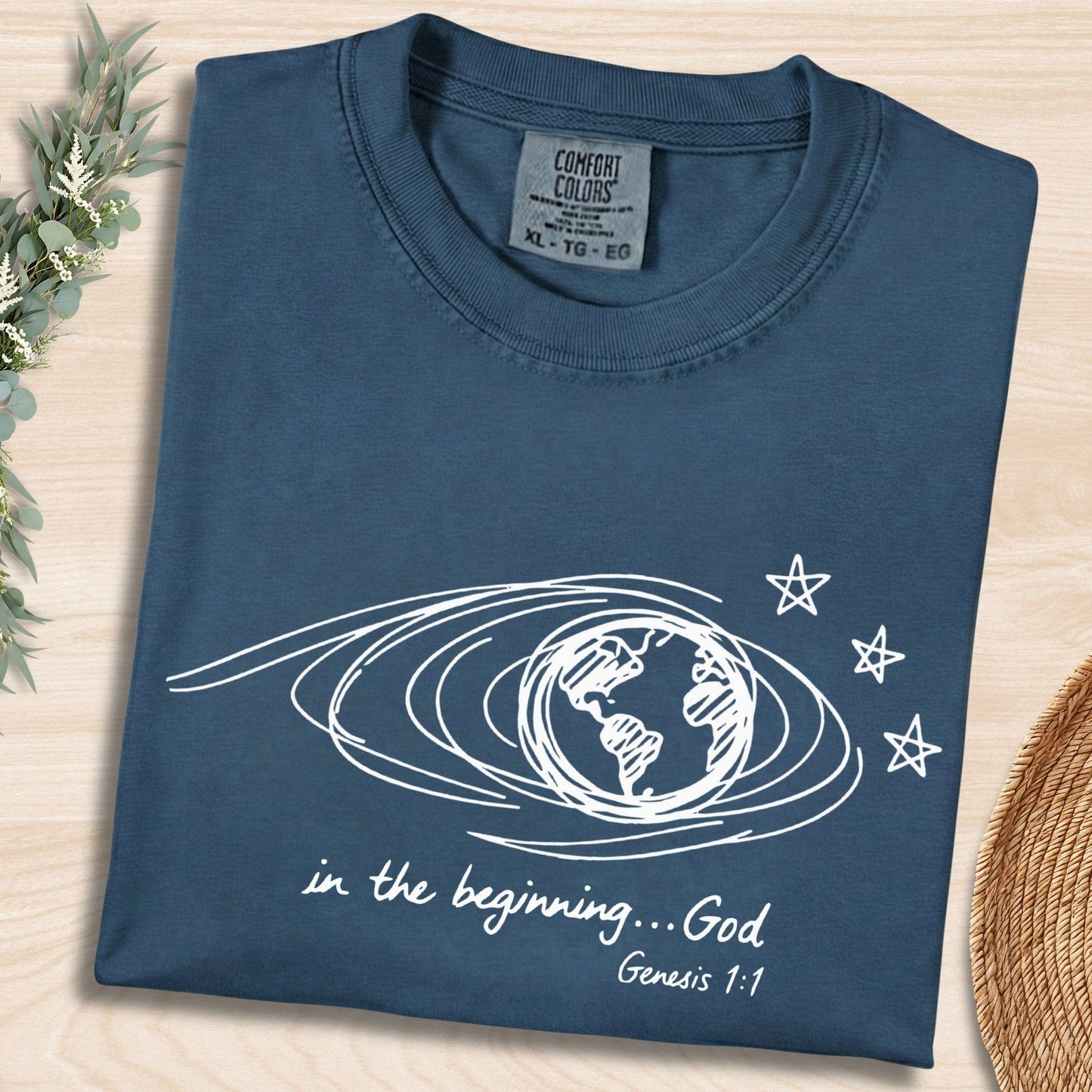 Midnight Blue Comfort Colors 1717 tshirt with white hand-drawn earth illustration and Bible verse. A vintage-style Christian women tee featuring Genesis 1:1, designed for modern US faith wear apparel.