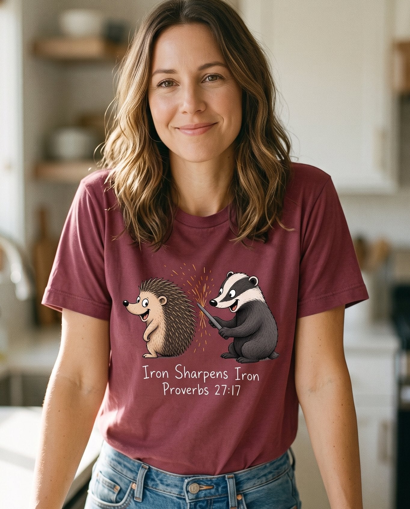 Iron Sharpens Iron Proverbs 27 17 – Berry women's Christian tee, lifestyle photo in morning kitchen setting – Badger filing down a hedgehog's quills with sparks flying – Proverbs 27:17 – She Wears Faith