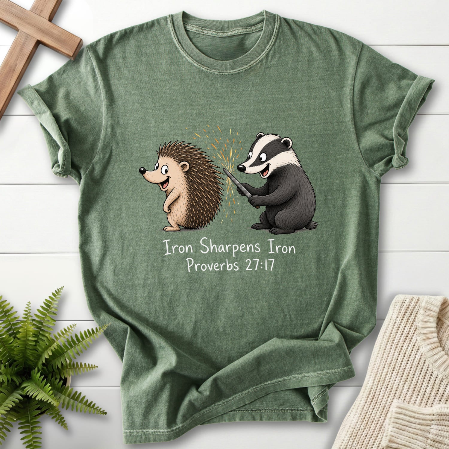 Flatlay of a Moss Bible verse tee with "Iron Sharpens Iron Proverbs 27:17 T-Shirt" Proverbs 27:17.