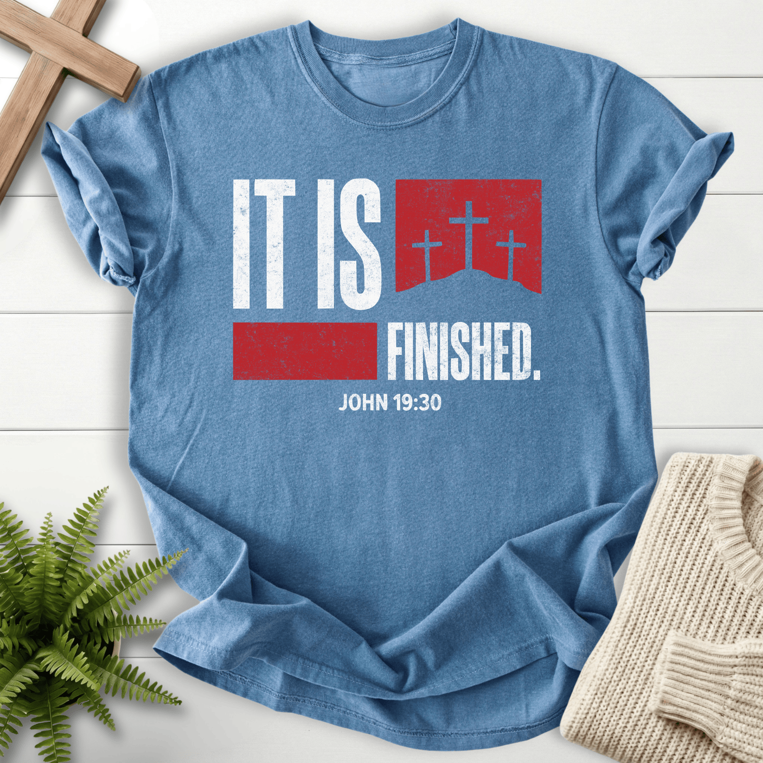 Blue Jean women's Christian t-shirt with "It Is Finished" and three crosses on a red banner, inspired by John 19:30