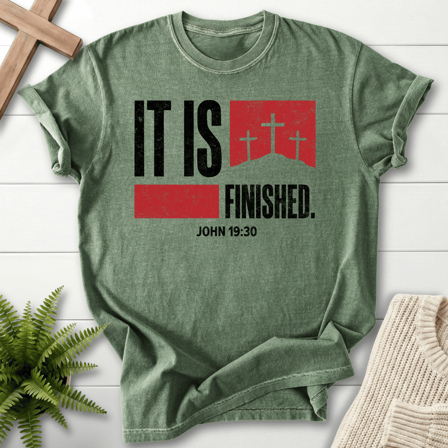 Moss women's Christian t-shirt with bold "It Is Finished" text and a cross graphic, inspired by John 19:30