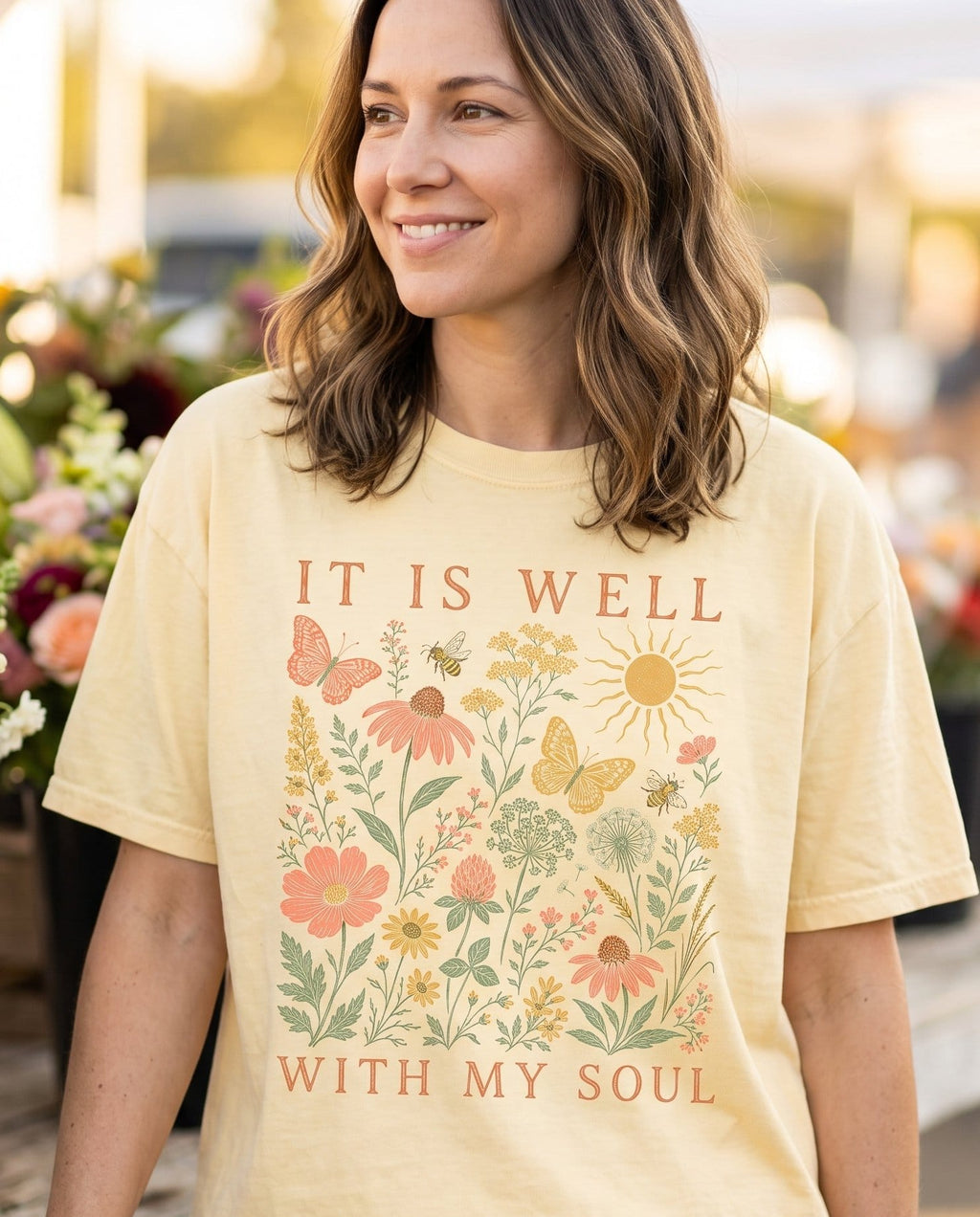 It Is Well Wildflower – Banana women's Christian tee, lifestyle photo in farmers market – Vintage botanical wildflowers – She Wears Faith