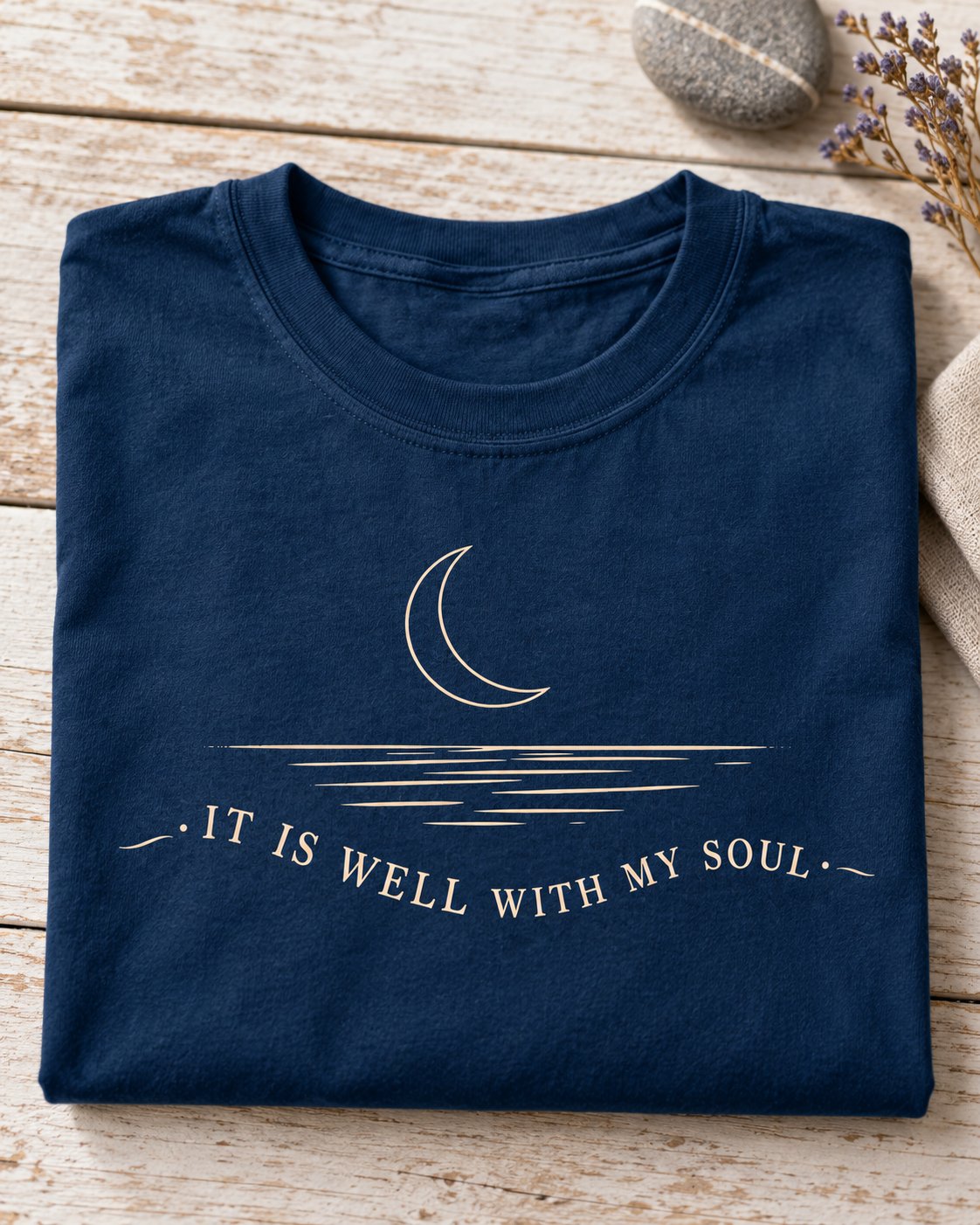 It Is Well With My Soul Minimalist, Navy women's Christian tee, lifestyle photo in folded flat lay, crescent moon over water with IT IS WELL WITH MY SOUL, She Wears Faith