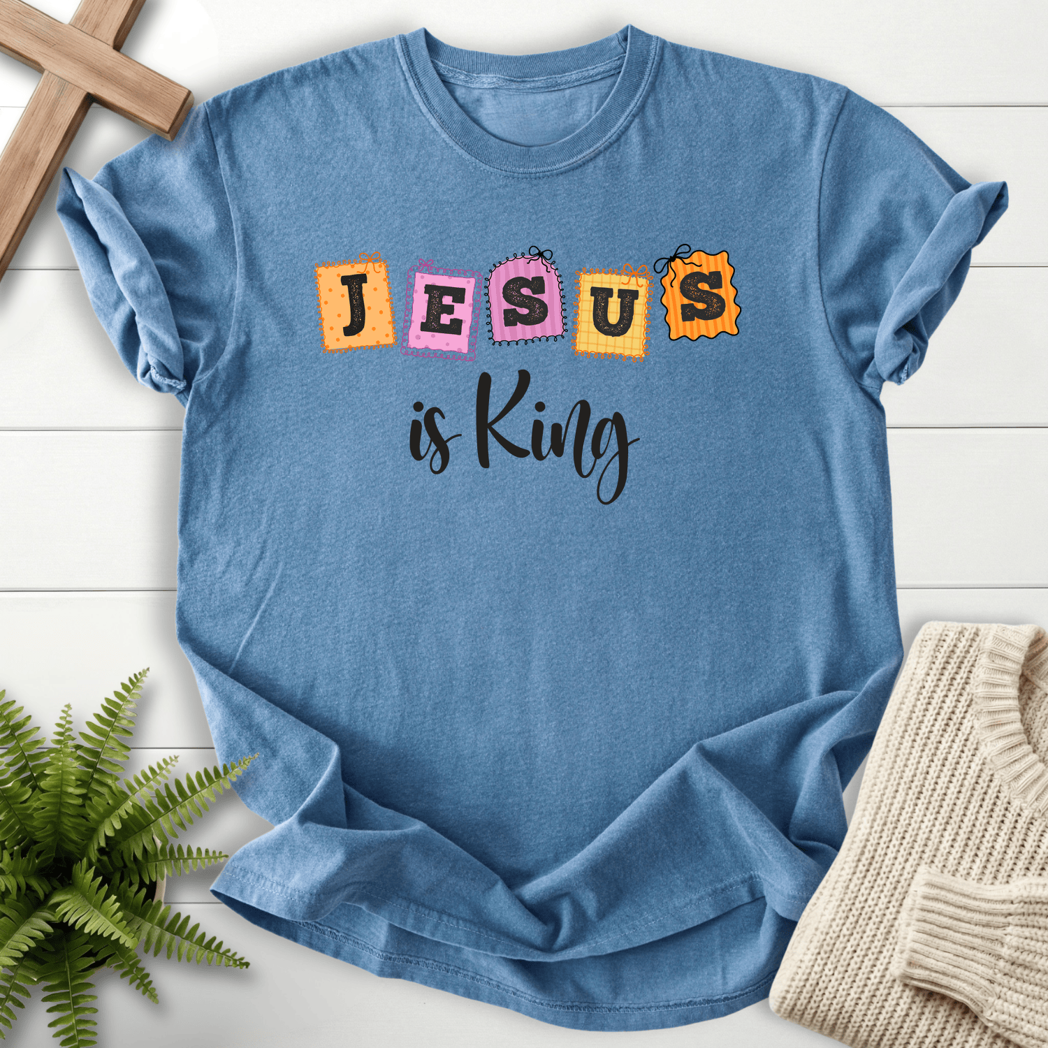 Blue Jean women's Christian t-shirt with a playful colorful patchwork "JESUS is King" graphic