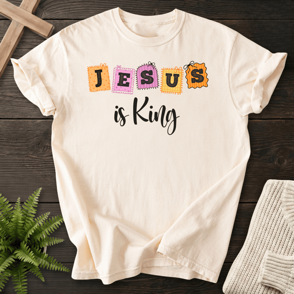 Ivory women's Christian t-shirt with playful patchwork "JESUS is King" stamp letters in orange and pink