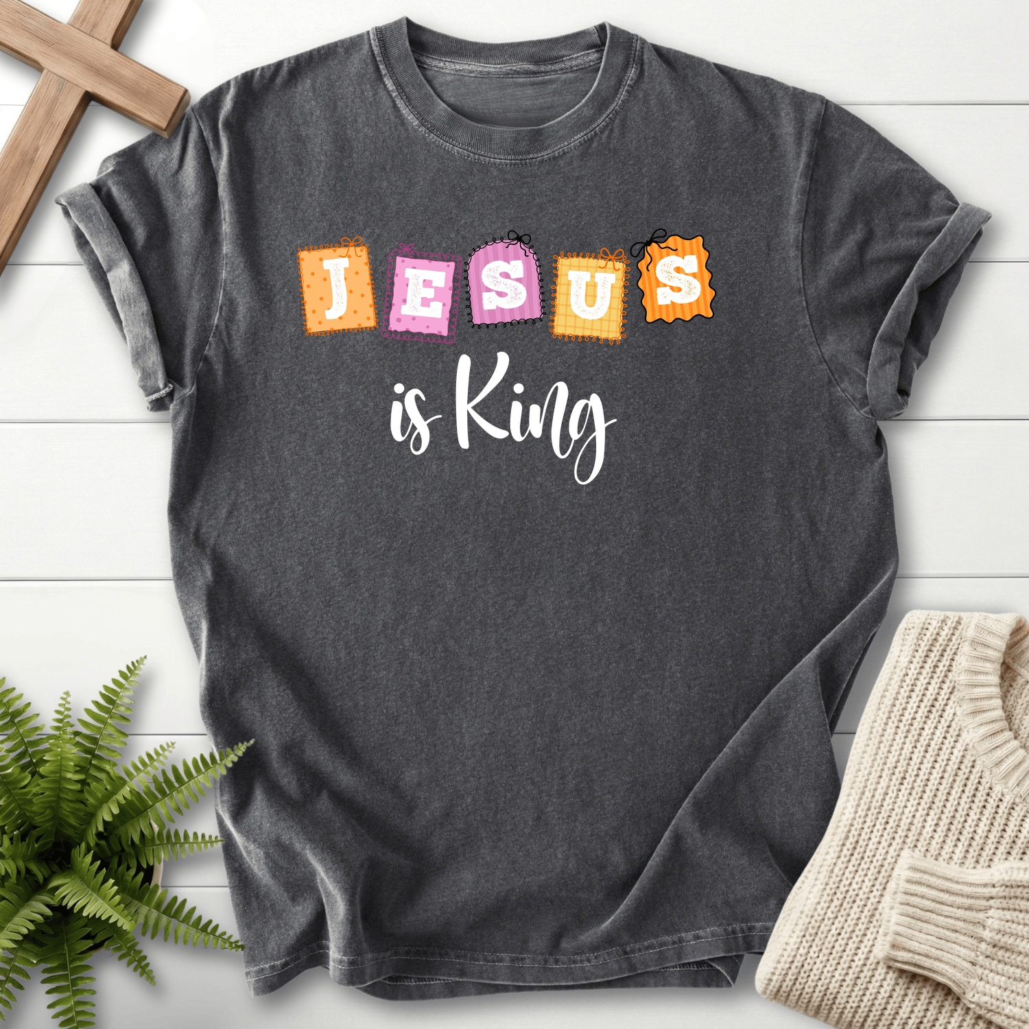 Pepper women's Christian t-shirt with a colorful "JESUS is King" patchwork stamp design