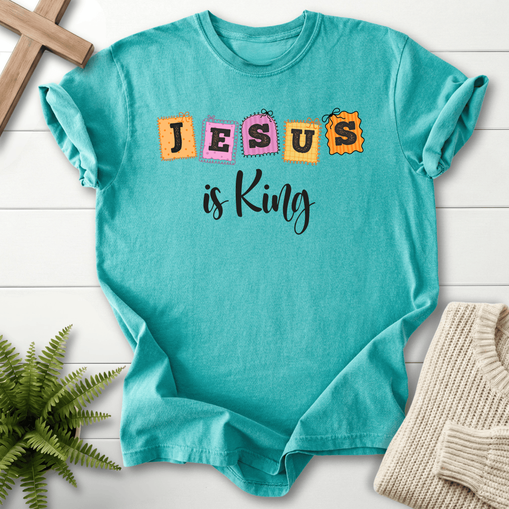 Seafoam women's Christian t-shirt with whimsical patchwork "JESUS is King" letter stamps