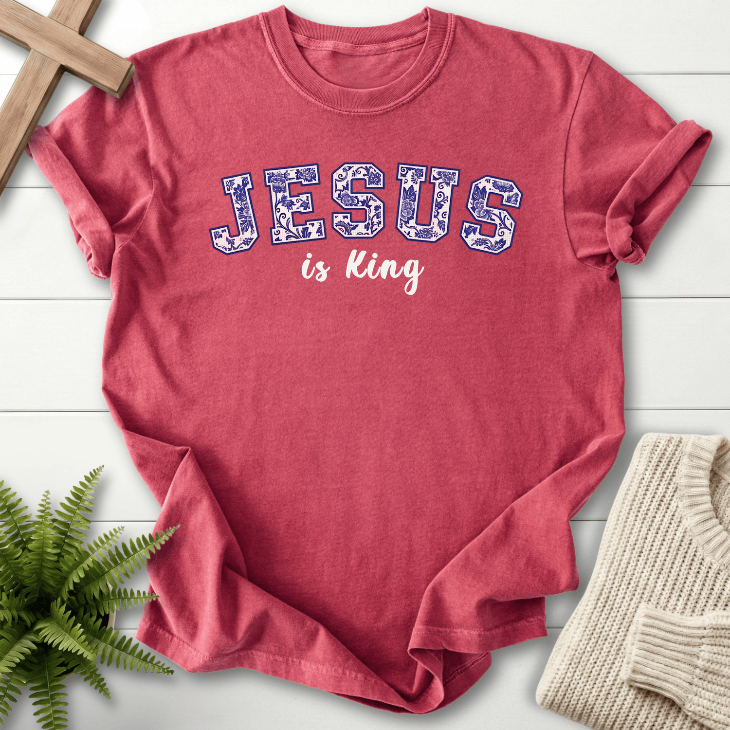 Crimson women's Christian t-shirt with a floral-filled varsity "JESUS is King" graphic