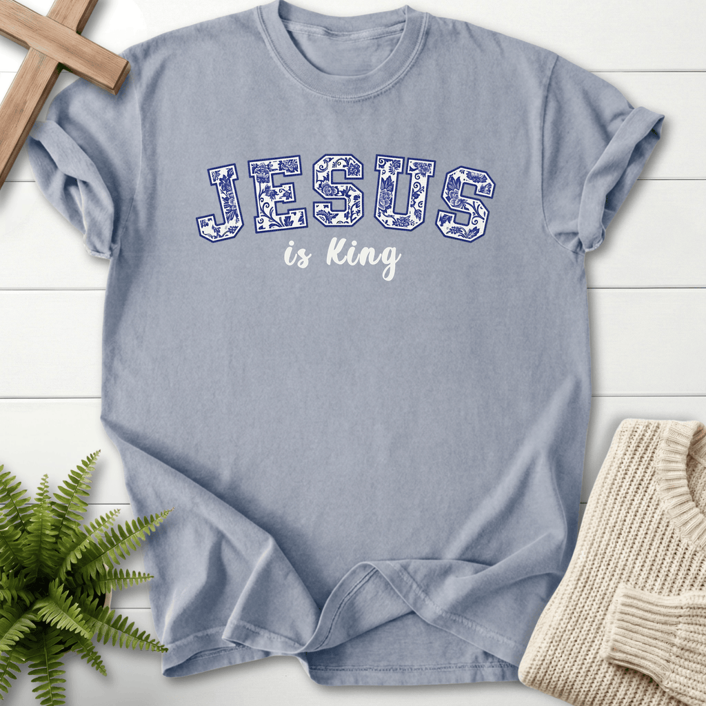 Granite women's Christian t-shirt with blue floral "JESUS is King" collegiate lettering, She Wears Faith