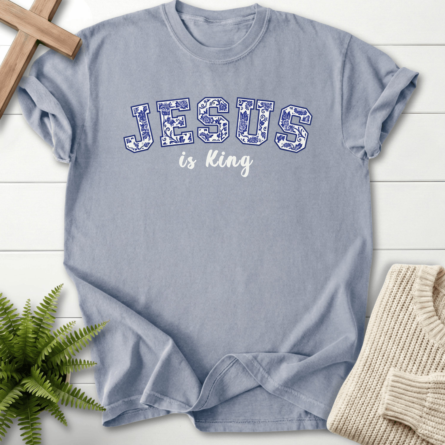 Granite women's Christian t-shirt with blue floral "JESUS is King" collegiate lettering, She Wears Faith