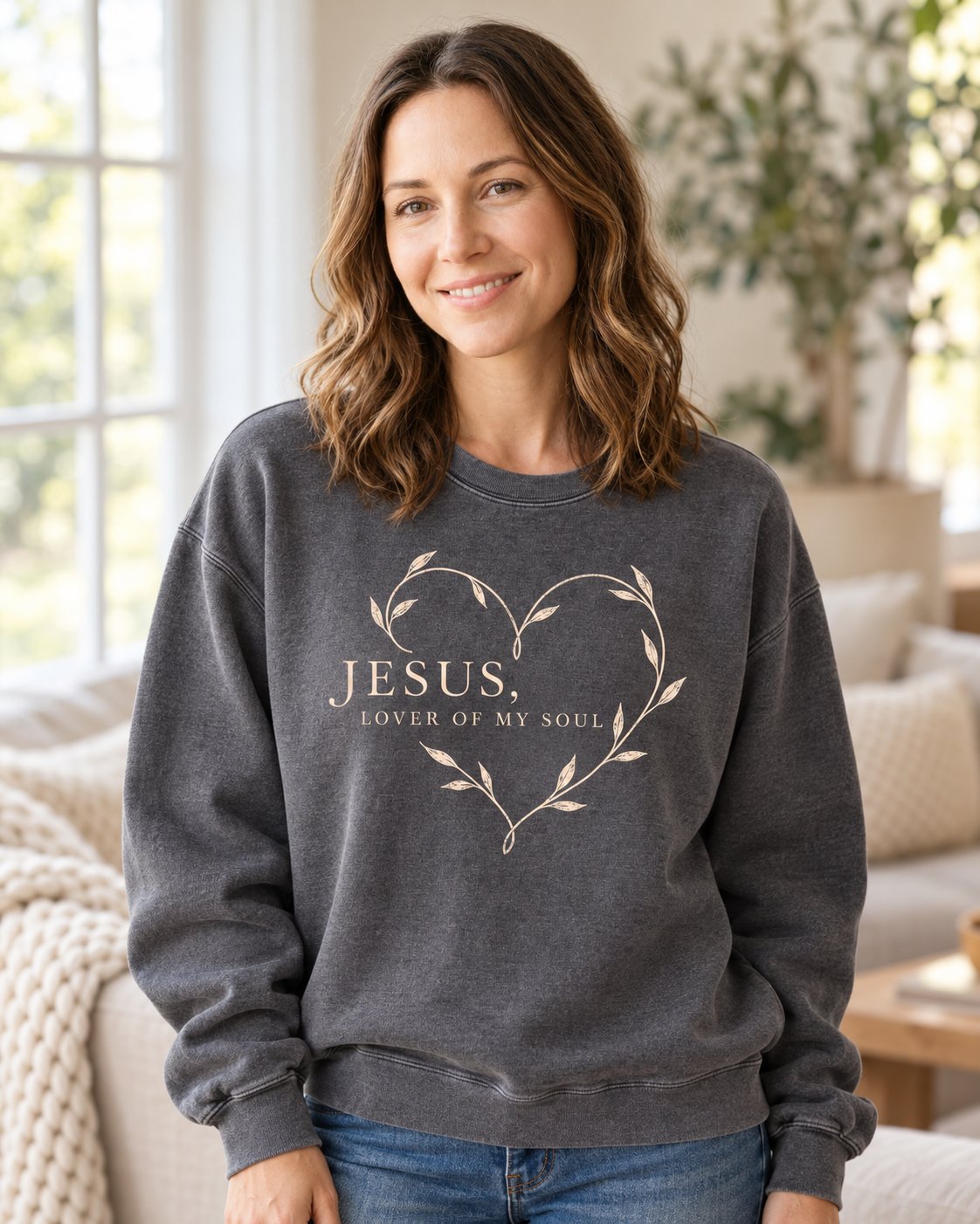 Jesus Lover of My Soul, Pepper women's Christian sweatshirt, lifestyle photo in cozy living room, leafy vine heart around JESUS LOVER OF MY SOUL, She Wears Faith