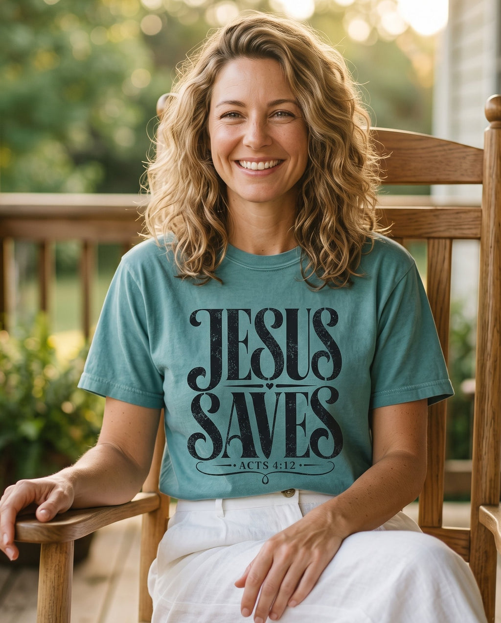 Jesus Saves Acts 4:12 – Chalky Mint women's Christian tee, lifestyle photo in sunny porch – Bold distressed black display lettering JESUS SAVES with a small heart – Acts 4:12 – She Wears Faith