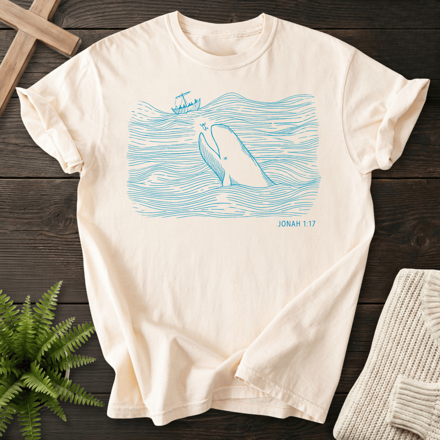 Ivory women's Christian t-shirt with minimalist teal whale and wave line art, inspired by Jonah 1:17