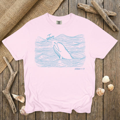 Comfort Colors 1717 blossom pink Christian women’s T-shirt with a gentle blue line-art scene of Jonah and the whale from Jonah 1:17. A soft, feminine faith tee ideal for US faith wear and modern scripture-inspired apparel.