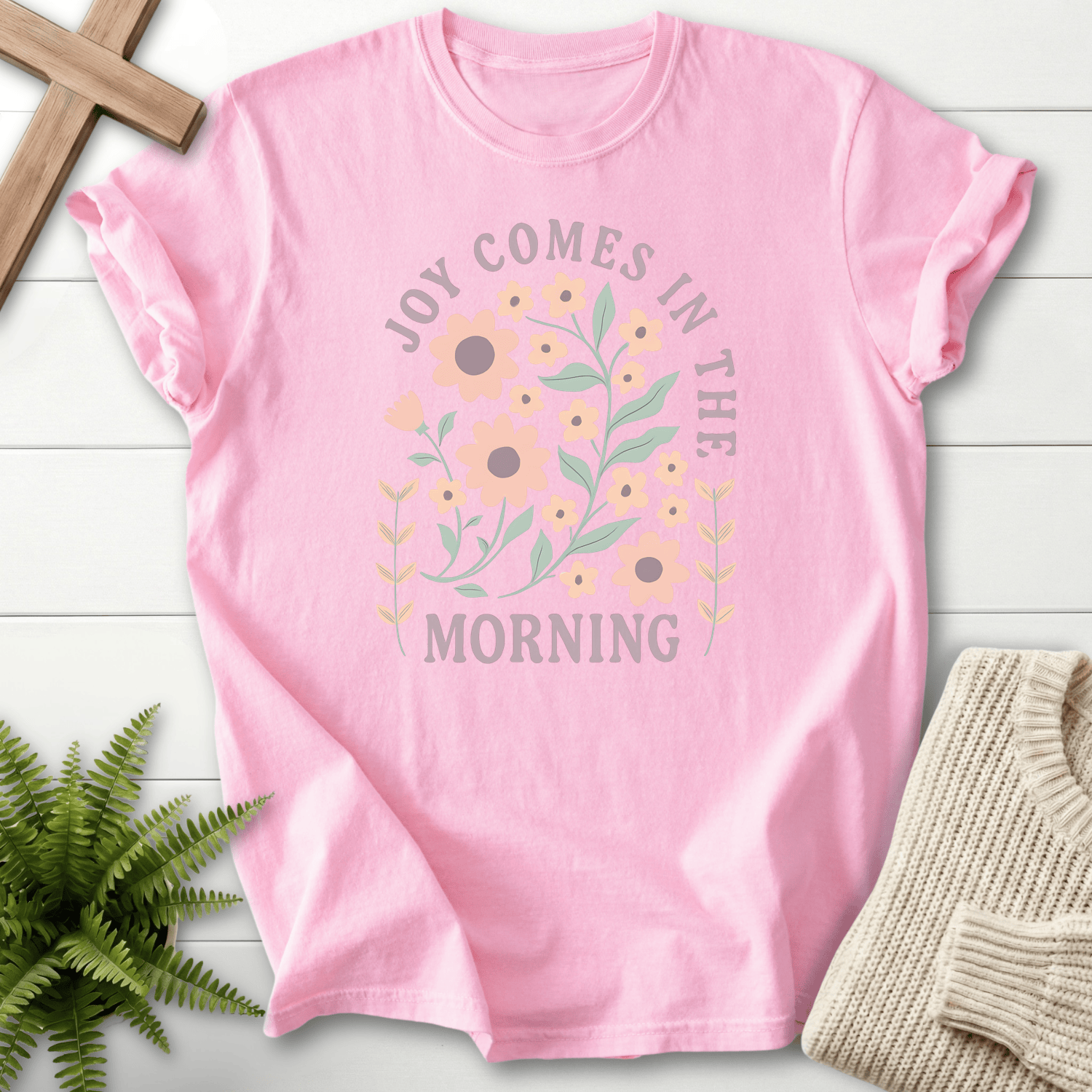 Blossom women's Christian t-shirt with a pink floral boho design and arched "Joy Comes in the Morning" lettering