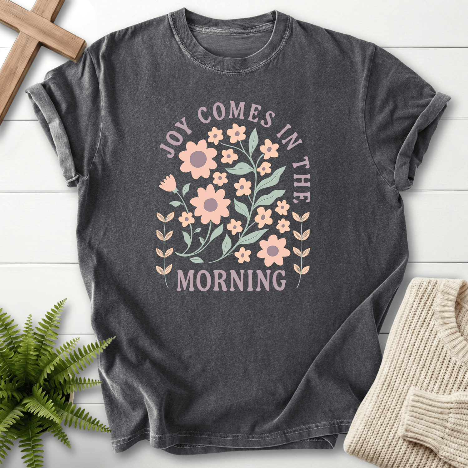 Pepper women's Christian t-shirt with a boho floral arch and "Joy Comes in the Morning" text