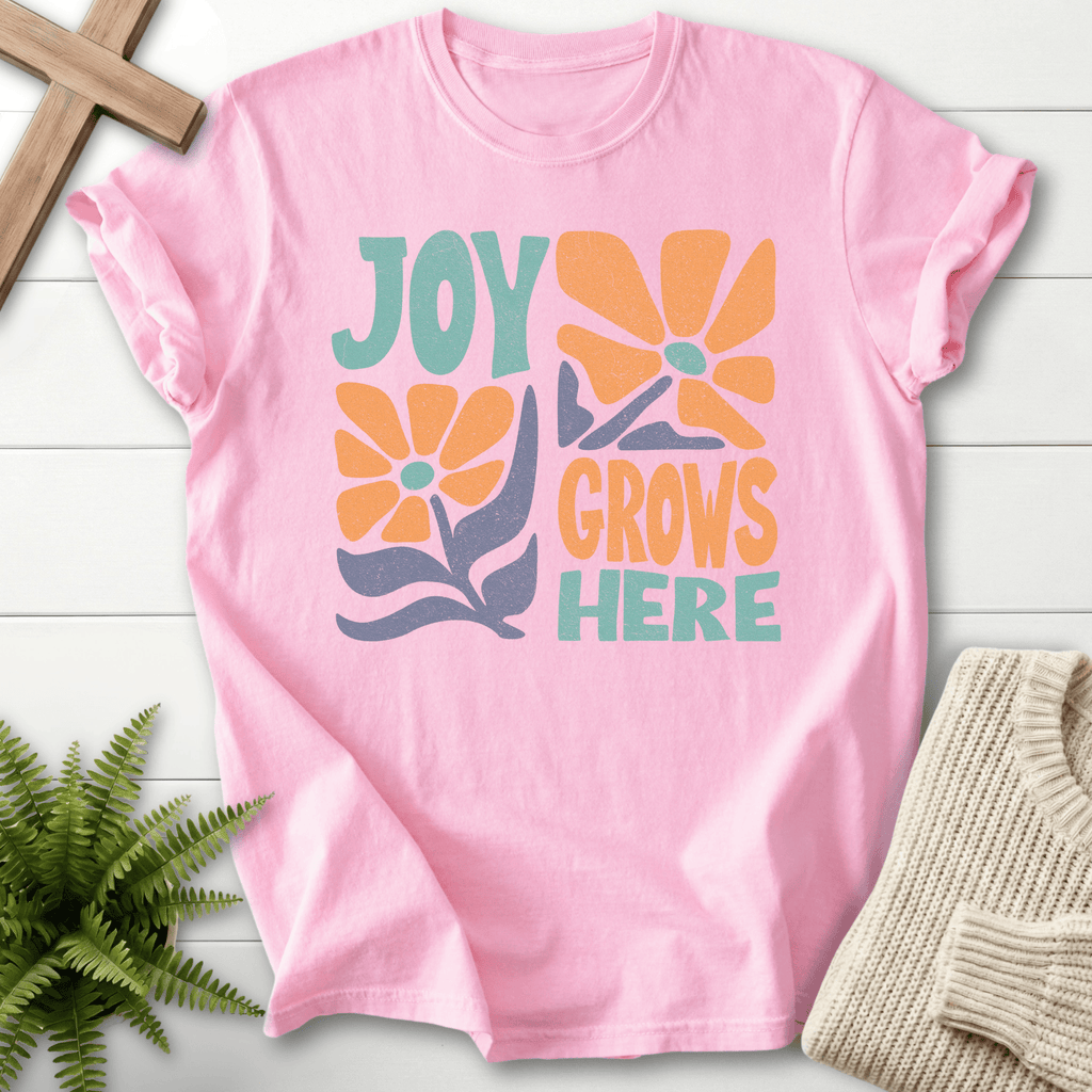Blossom women's Christian t-shirt with a bold retro "Joy Grows Here" orange daisy and teal lettering