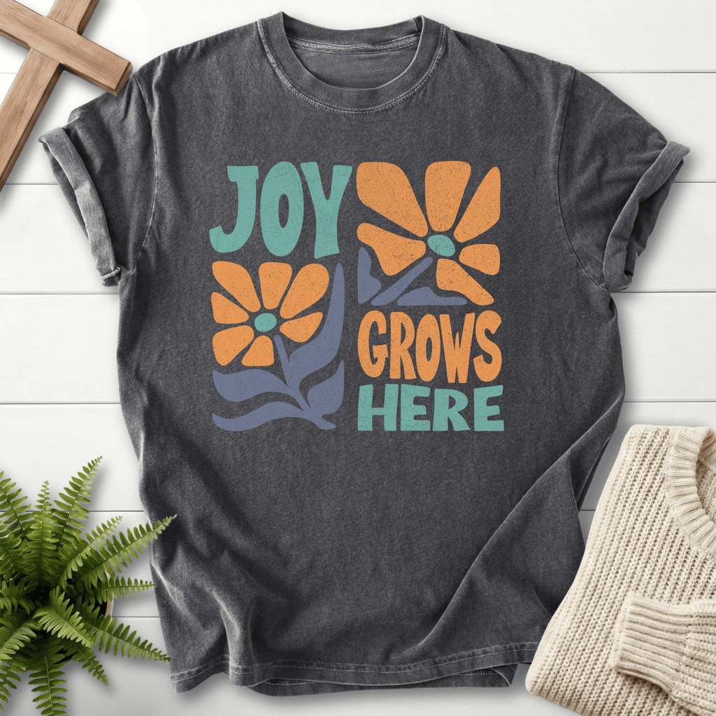 Pepper women's Christian t-shirt with a retro orange daisy "Joy Grows Here" graphic, She Wears Faith