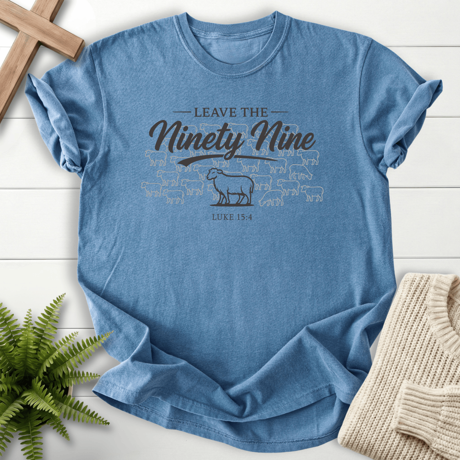 Blue Jean women's Christian t-shirt with lone lamb beside the flock and "Leave the Ninety Nine" design, inspired by Luke 15:4.