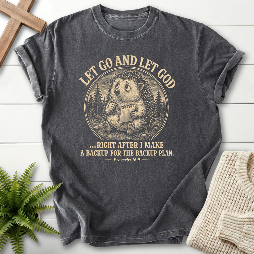 Flat lay of a Pepper Comfort Colors 1717 women's Christian tee featuring "Let Go and Let God Backup Plan T-Shirt" Proverbs 16:9.