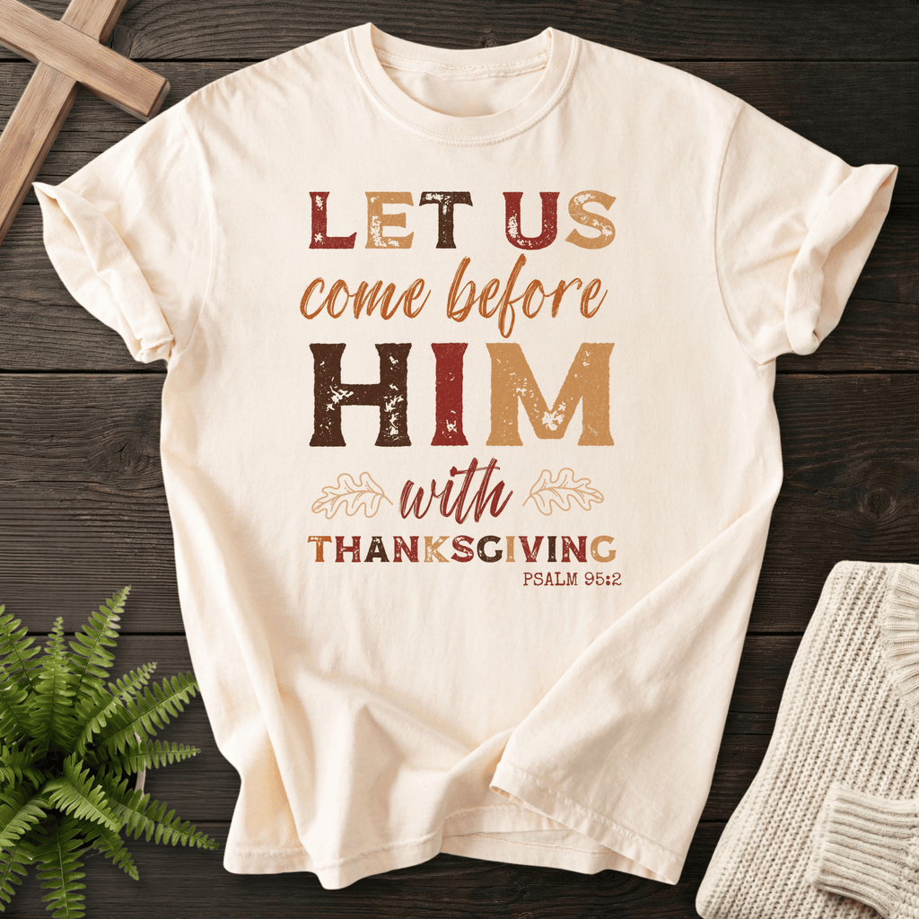 Ivory Christian t-shirt for women with autumn Let Us Come Before Him With Thanksgiving typography and oak leaf accents, inspired by Psalm 95:2.