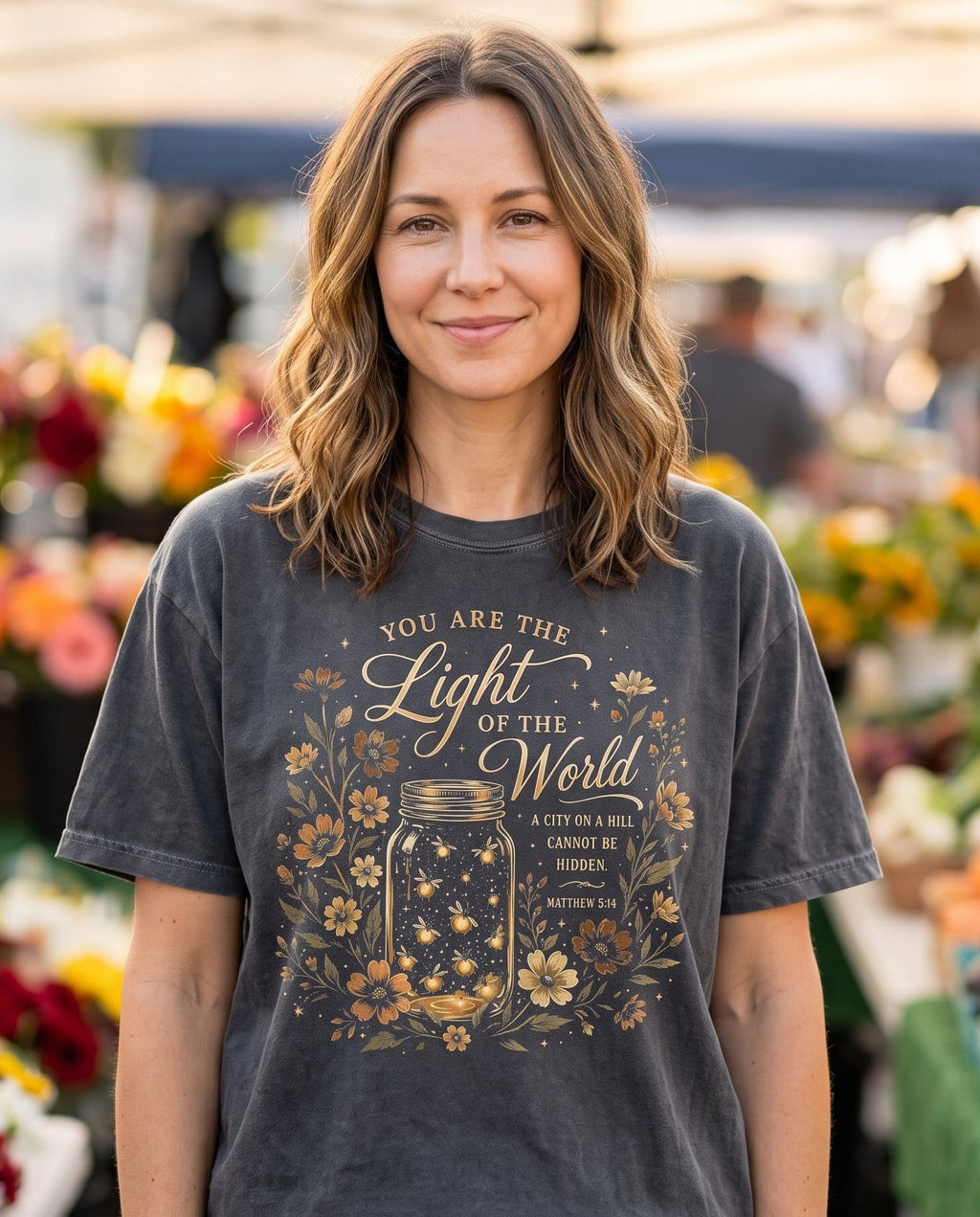 Light of the World – Pepper women's Christian tee, lifestyle photo in farmers market – Mason jar full of glowing fireflies surrounded by wildflowers – Matthew 5:14 – She Wears Faith