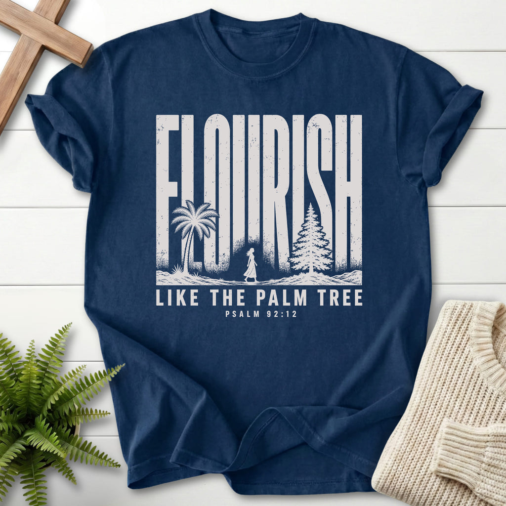 Flatlay of a Navy Comfort Colors 1717 garment-dyed Christian tee with "Like The Palm Flourish Scripture T-Shirt" Psalm 92:12 From Printify.