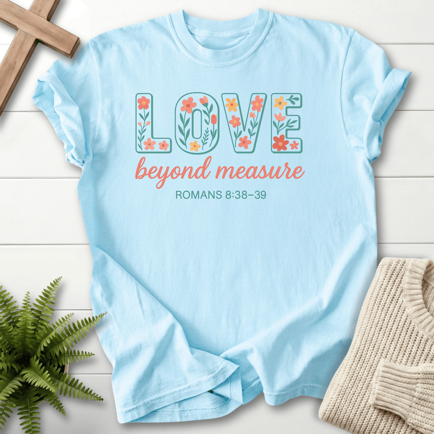 Chambray women's faith t-shirt with "Love Beyond Measure" floral design, inspired by Romans 8:38-39.
