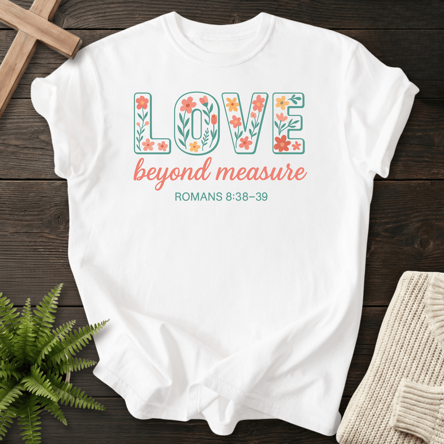 White women's Christian t-shirt with colorful floral lettering, inspired by Romans 8:38-39.