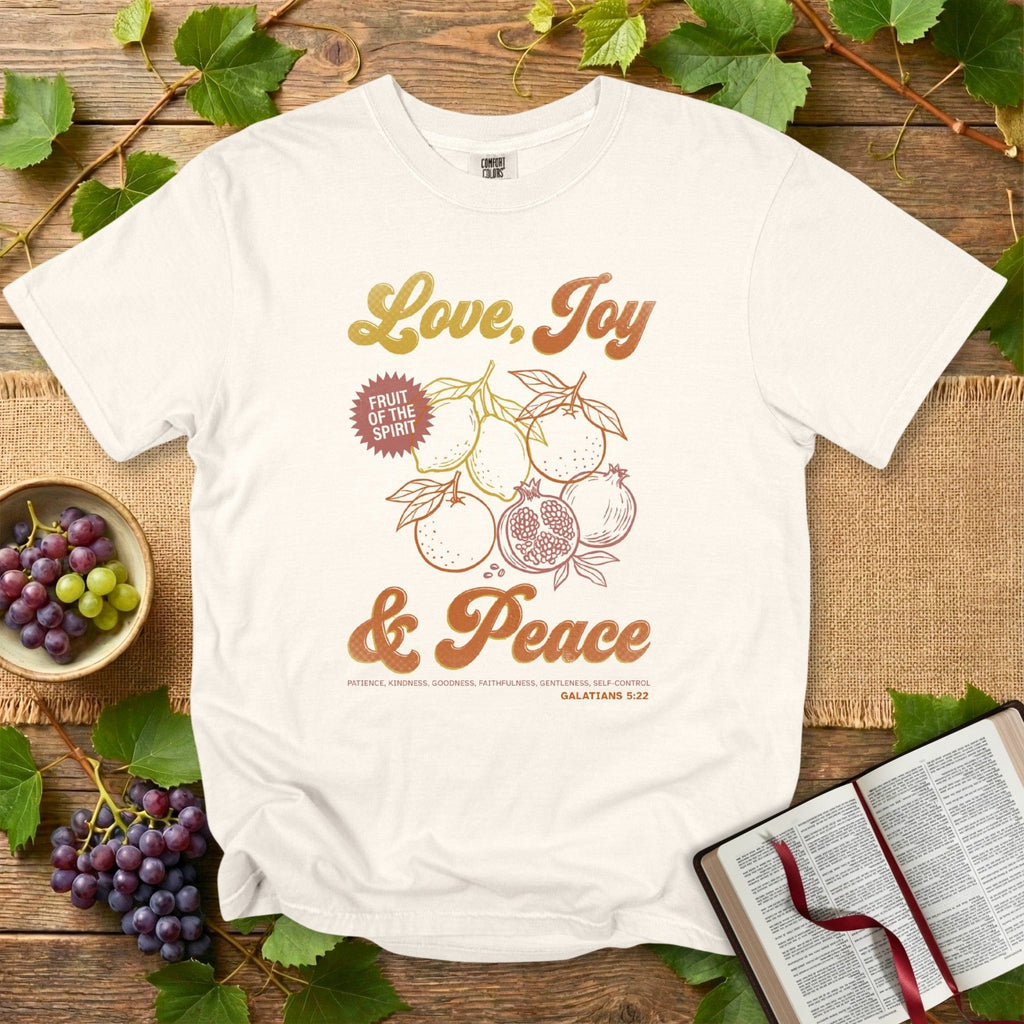 Comfort Colors 1717 ivory Christian women tee displaying Fruit of the Spirit graphics and the message Love, Joy & Peace from Galatians 5:22. Stylish US faith wear with soft, uplifting Christian artwork