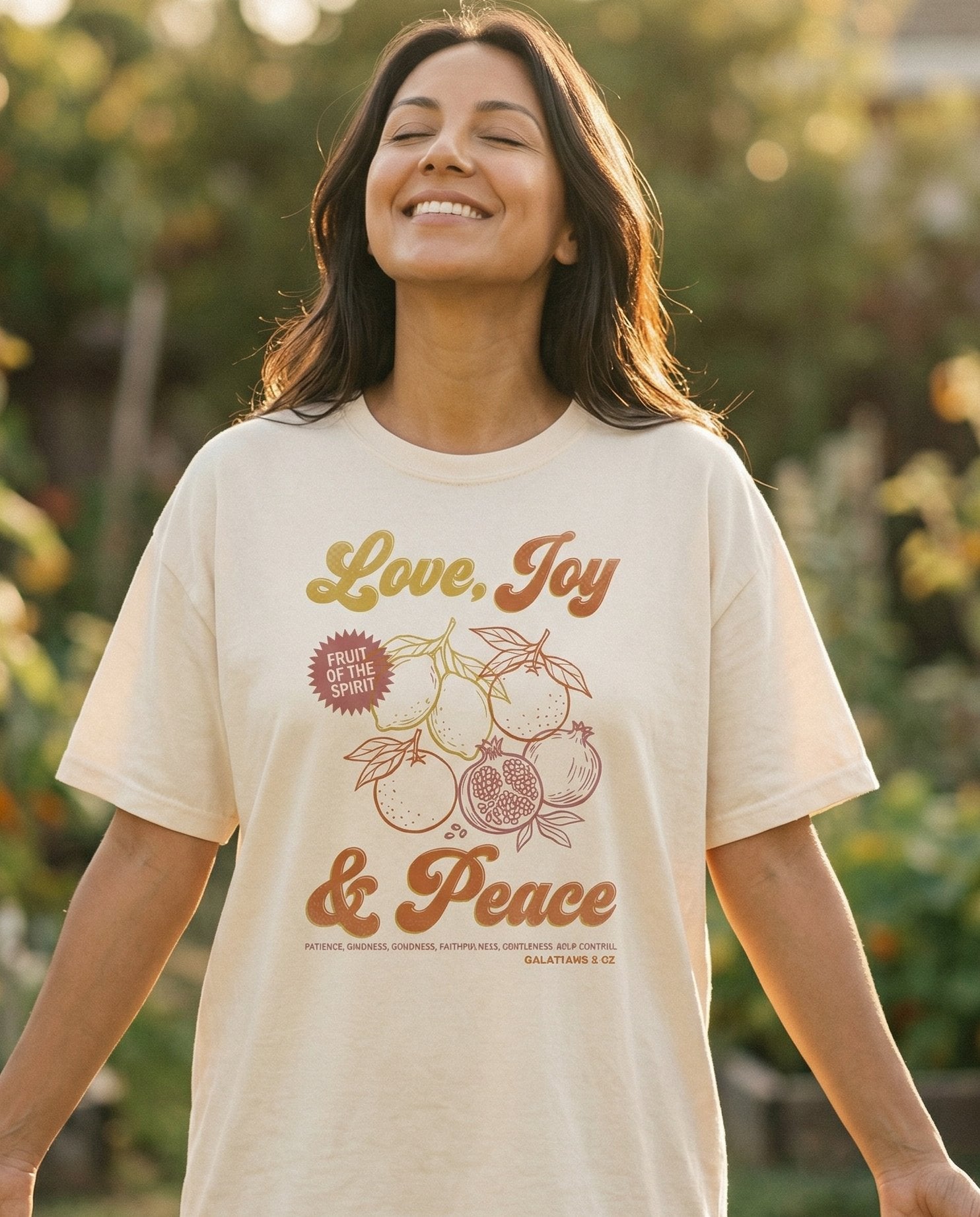 Love, Joy & Peace – Ivory women's Christian tee, lifestyle photo in outdoor garden – Retro-style design with 'Love – Galatians 5:22 – She Wears Faith