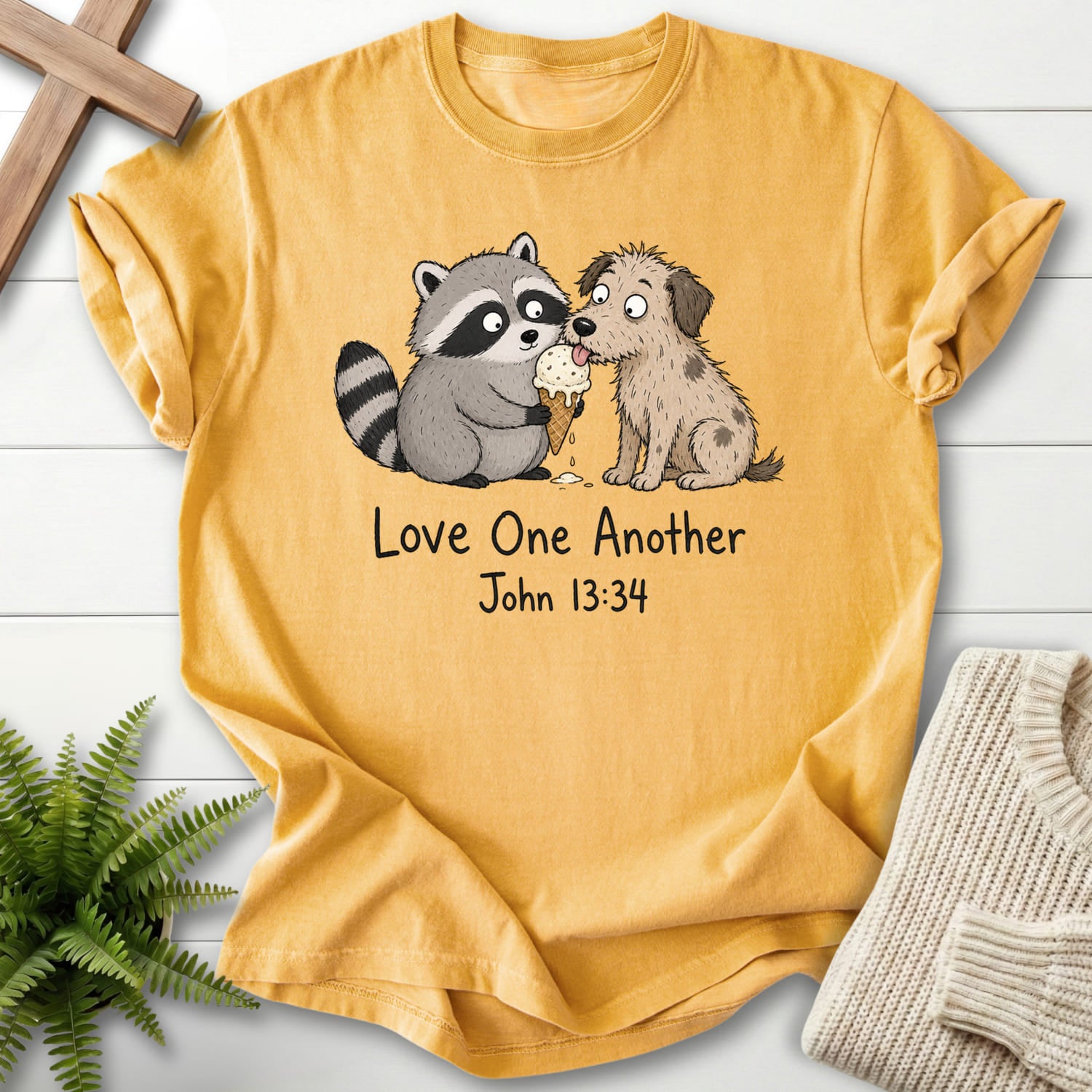 Mustard color option for the Love One Another Raccoon Scripture shirt with "Love One Another Raccoon Puppy T-Shirt" John 13:34.
