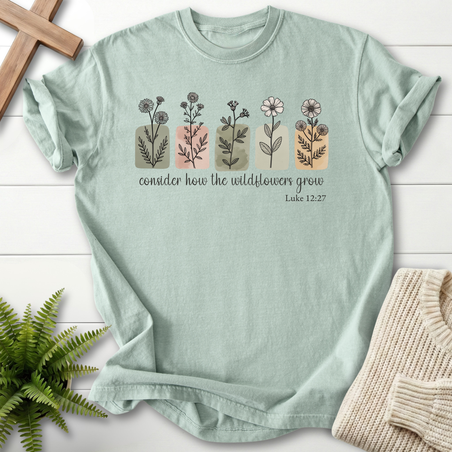 Bay garment-dyed Christian t-shirt with watercolor wildflower row, inspired by Luke 12:27.
