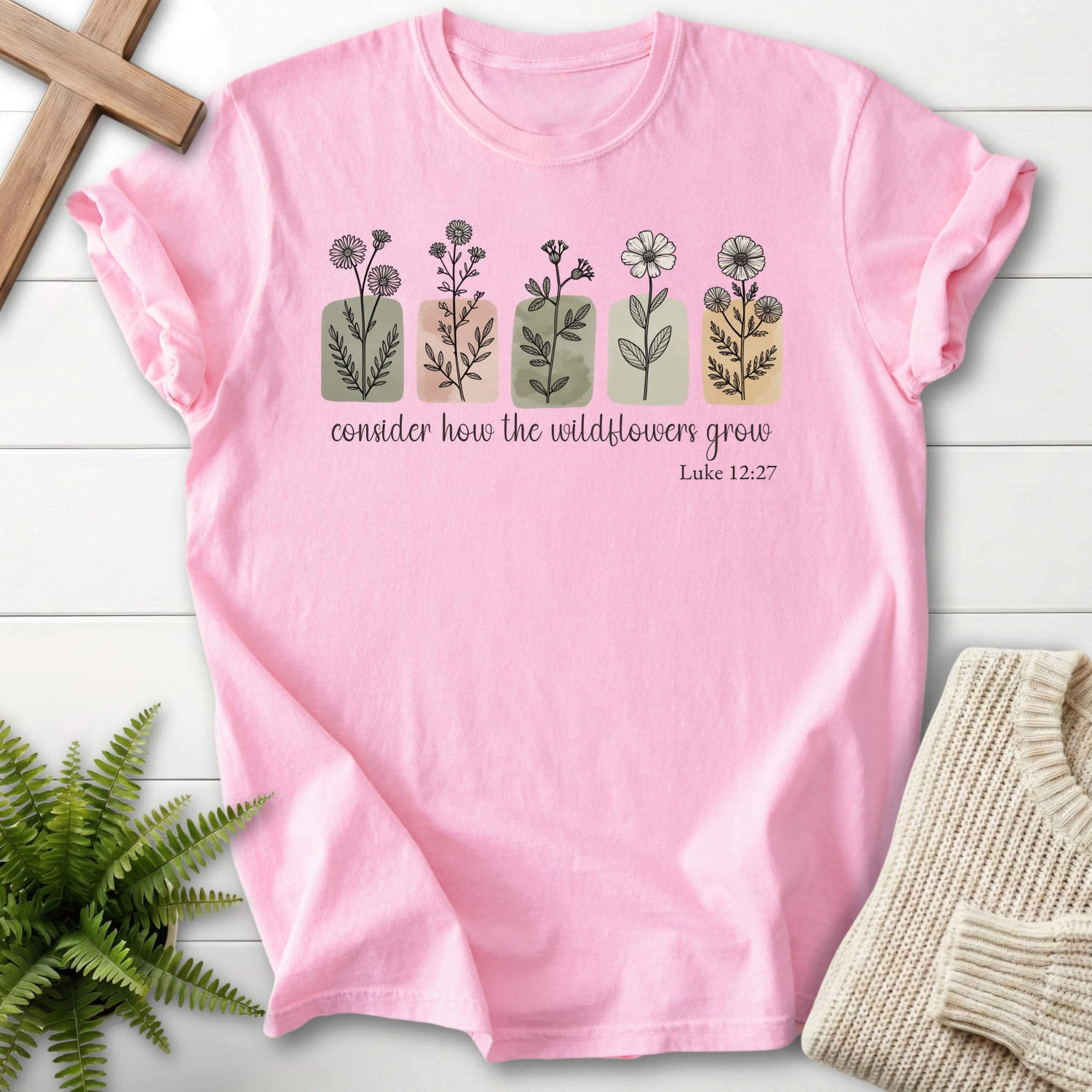 Blossom women's faith t-shirt with five wildflower stems and handwritten Scripture, inspired by Luke 12:27.