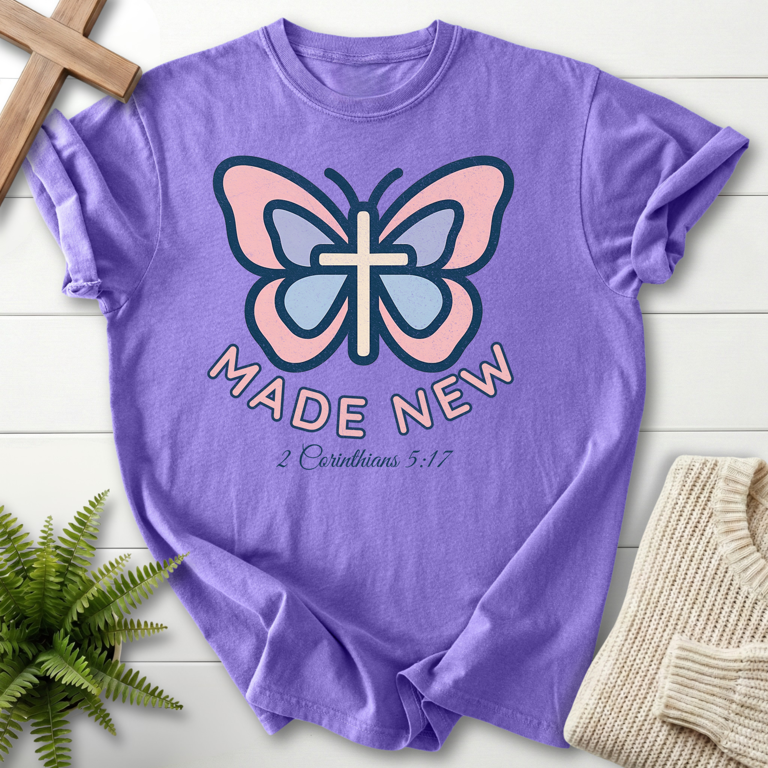 Violet women's Christian t-shirt with pastel butterfly cross design, inspired by 2 Corinthians 5:17.