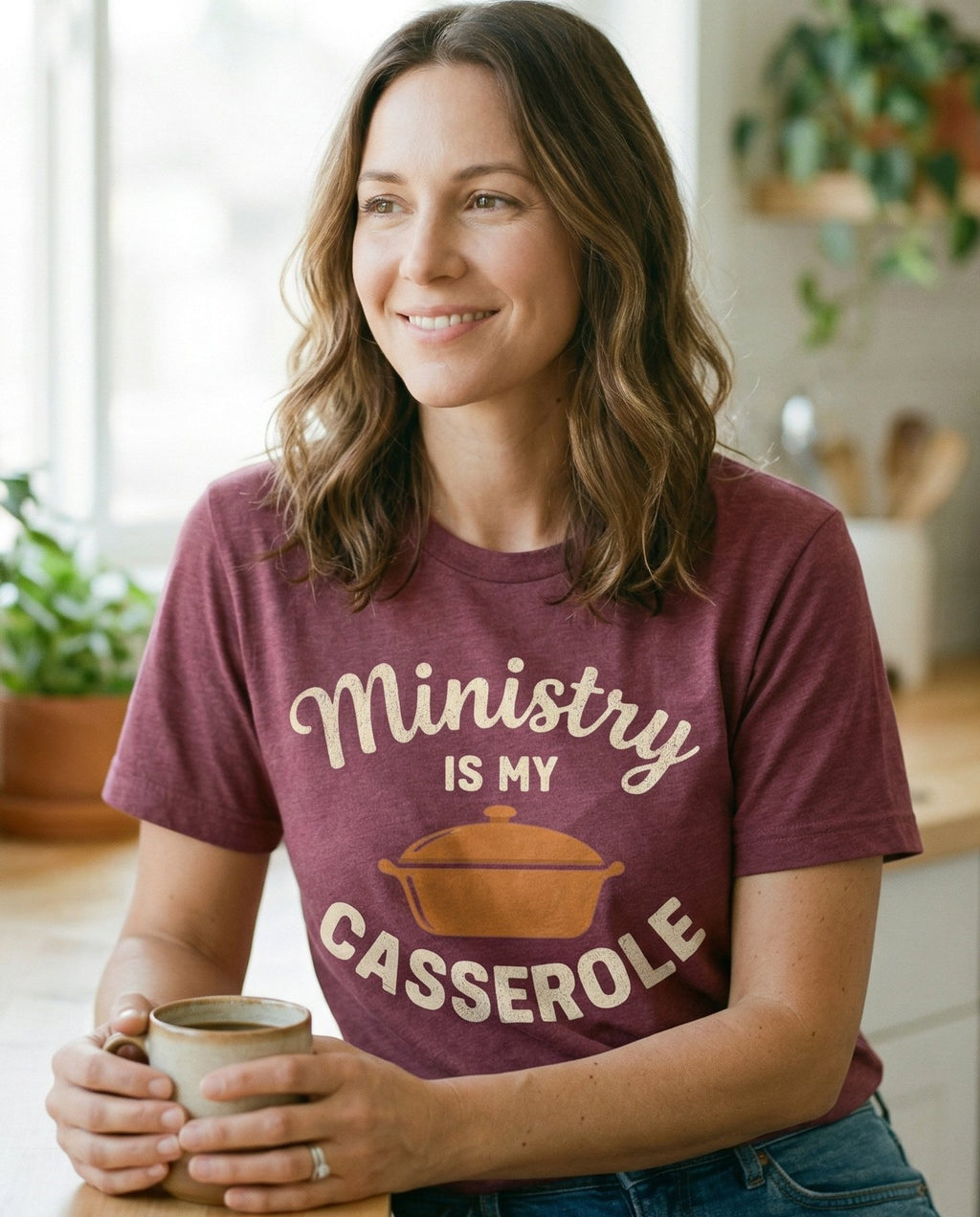 Ministry is My Casserole – Berry women's Christian tee, lifestyle photo in morning kitchen setting – Script and block lettering reading 'Ministry is My Casserole' with a c – She Wears Faith