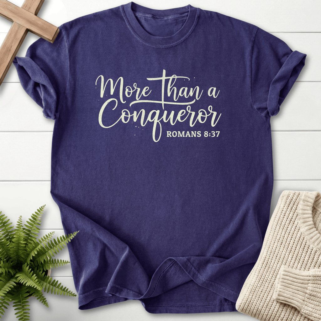 Grape women's faith t-shirt with elegant handwritten 'More Than a Conqueror' text, inspired by Romans 8:37.