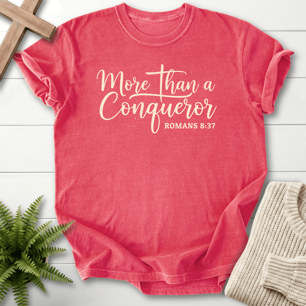 Watermelon women's Christian t-shirt with 'More Than a Conqueror' script, inspired by Romans 8:37.