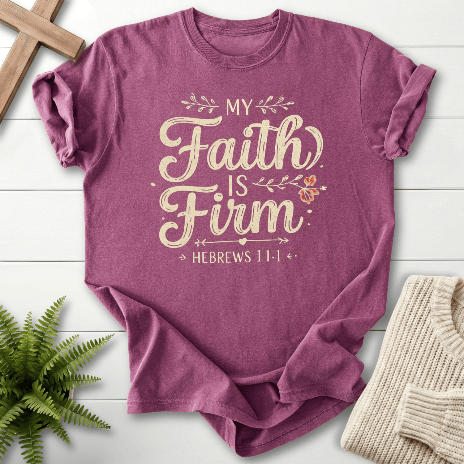 Berry women's Bible verse tee with 'My Faith is Firm' calligraphy script and vine details, inspired by Hebrews 11:1.