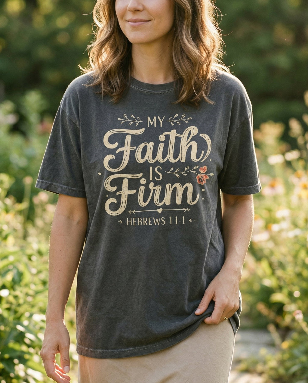 Faith is Firm T-shirt – Pepper women's Christian tee, lifestyle photo in outdoor garden – Elegant mixed typography with 'My Faith is Firm' in flowing calligraph – Hebrews 11:1 – She Wears Faith