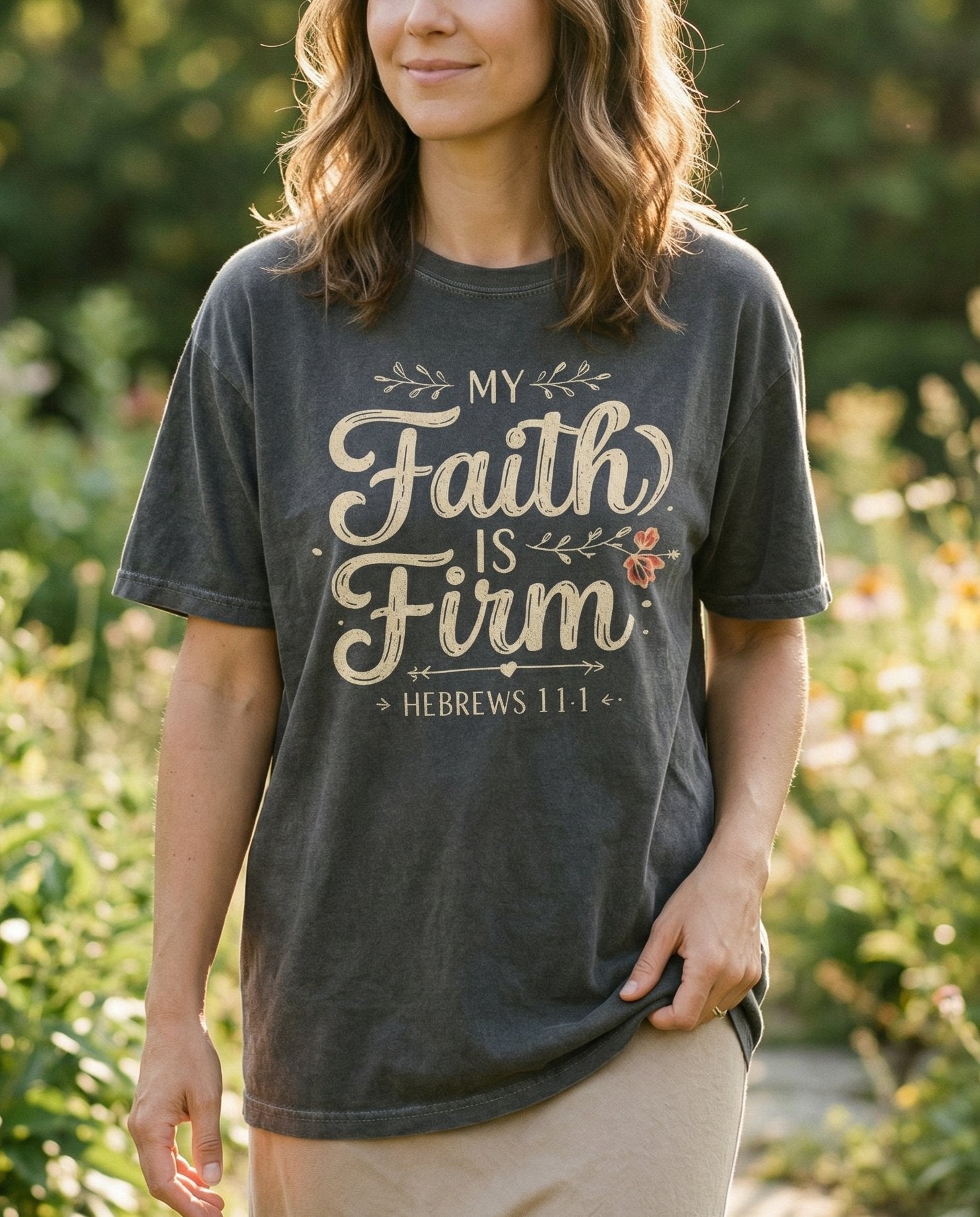 Faith is Firm T-shirt – Pepper women's Christian tee, lifestyle photo in outdoor garden – Elegant mixed typography with 'My Faith is Firm' in flowing calligraph – Hebrews 11:1 – She Wears Faith
