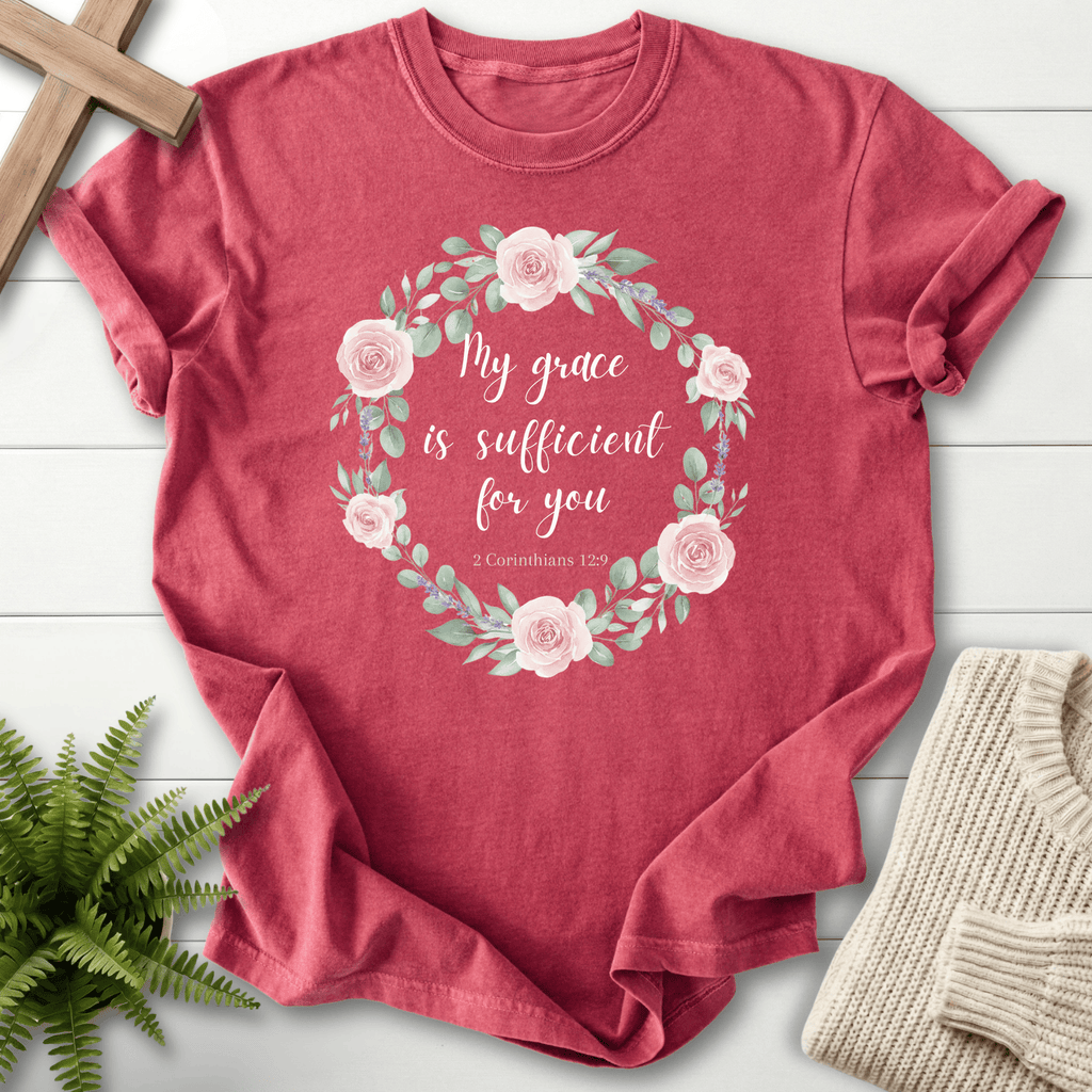 Crimson women's Bible verse tee with blush rose floral wreath and 'My grace is sufficient' lettering, inspired by 2 Corinthians 12:9.