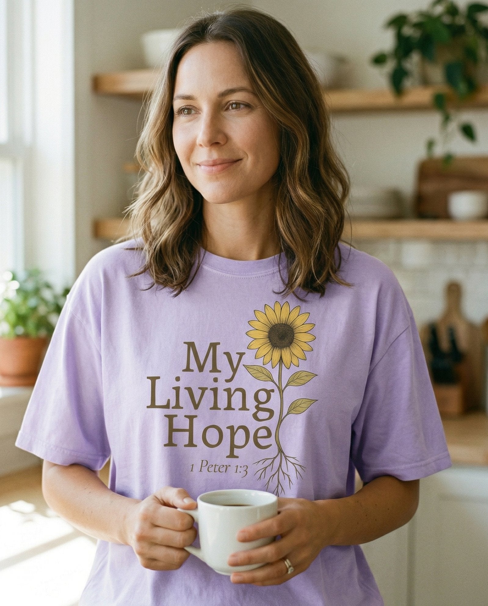 My Living Hope Sunflower – Orchid women's Christian tee, lifestyle photo in morning kitchen setting – Illustrated sunflower with roots and leaves paired with earthy serif t – 1 Peter 1:3 – She Wears Faith