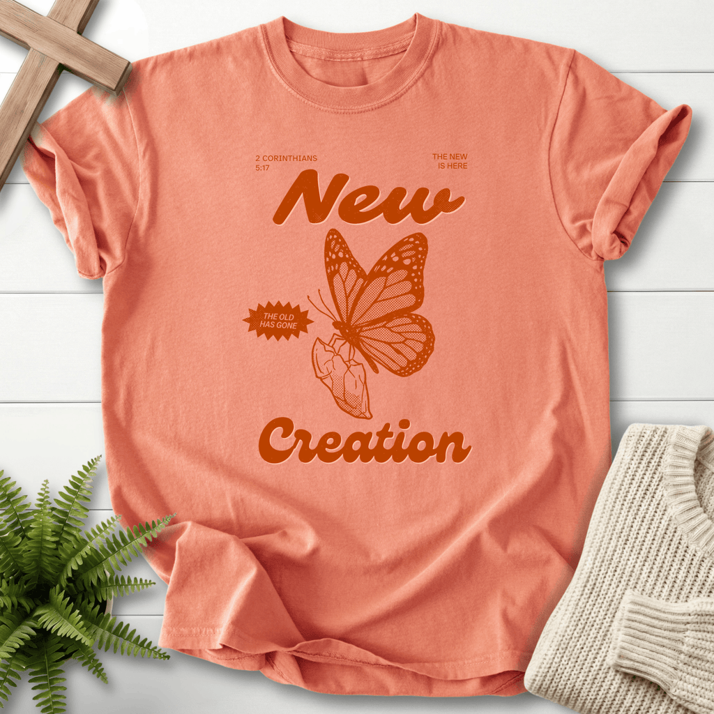Terracotta women's Christian t-shirt with monarch butterfly and retro 'New Creation' poster design, inspired by 2 Corinthians 5:17.