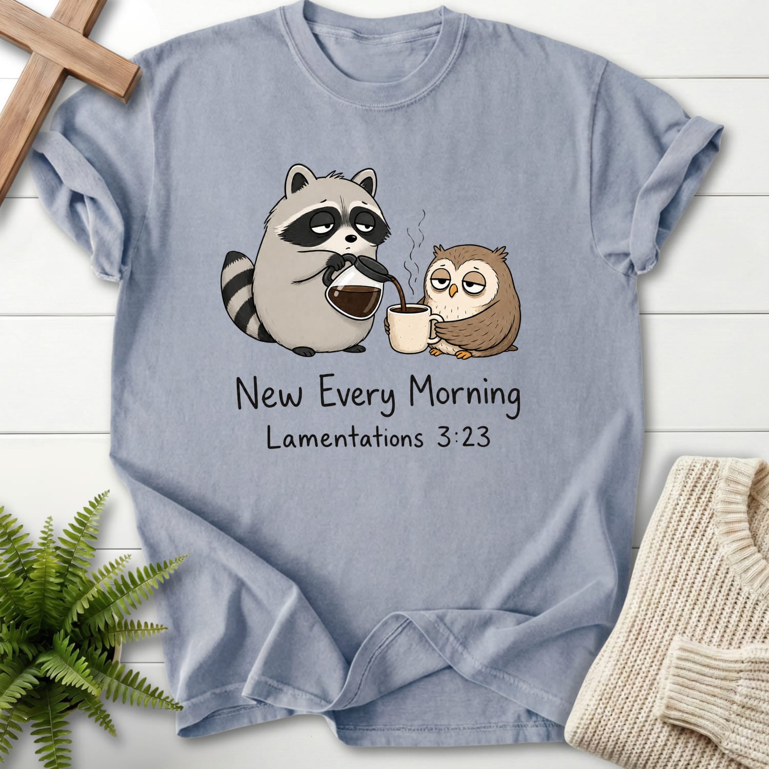 Flat lay of a Granite Bible verse tee featuring "New Every Morning Raccoon Owl T-Shirt" Lamentations 3:23.
