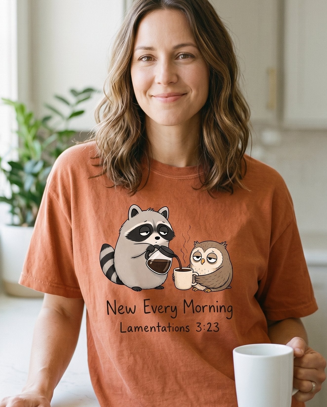 New Every Morning Raccoon Owl – Yam women's Christian tee, lifestyle photo in morning kitchen setting – Sleepy raccoon pouring coffee for an equally drowsy owl – Lamentations 3:23 – She Wears Faith